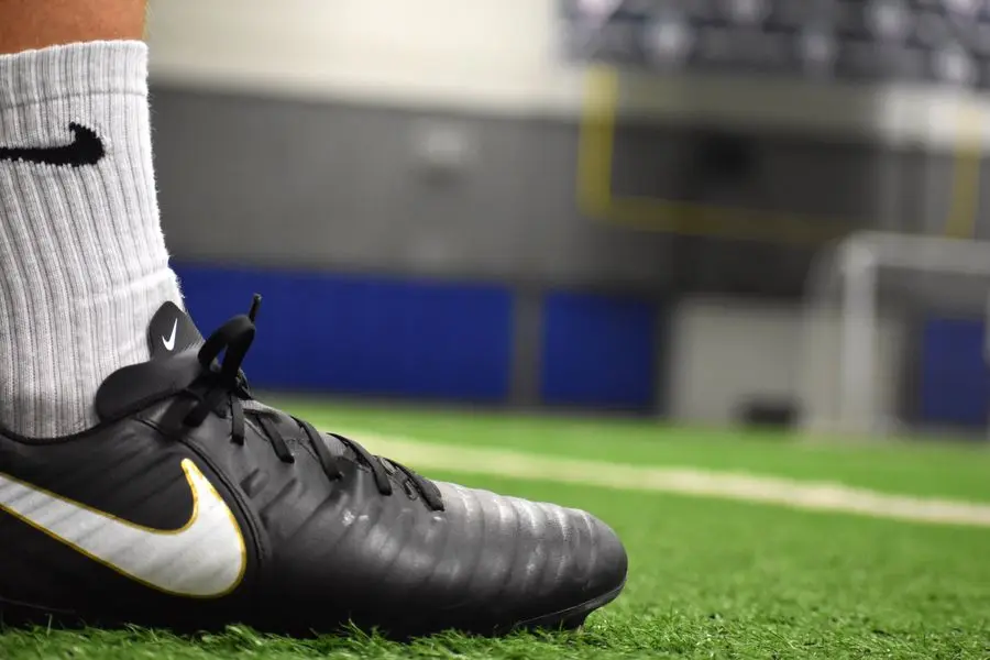 Close-up of a football boot on turf